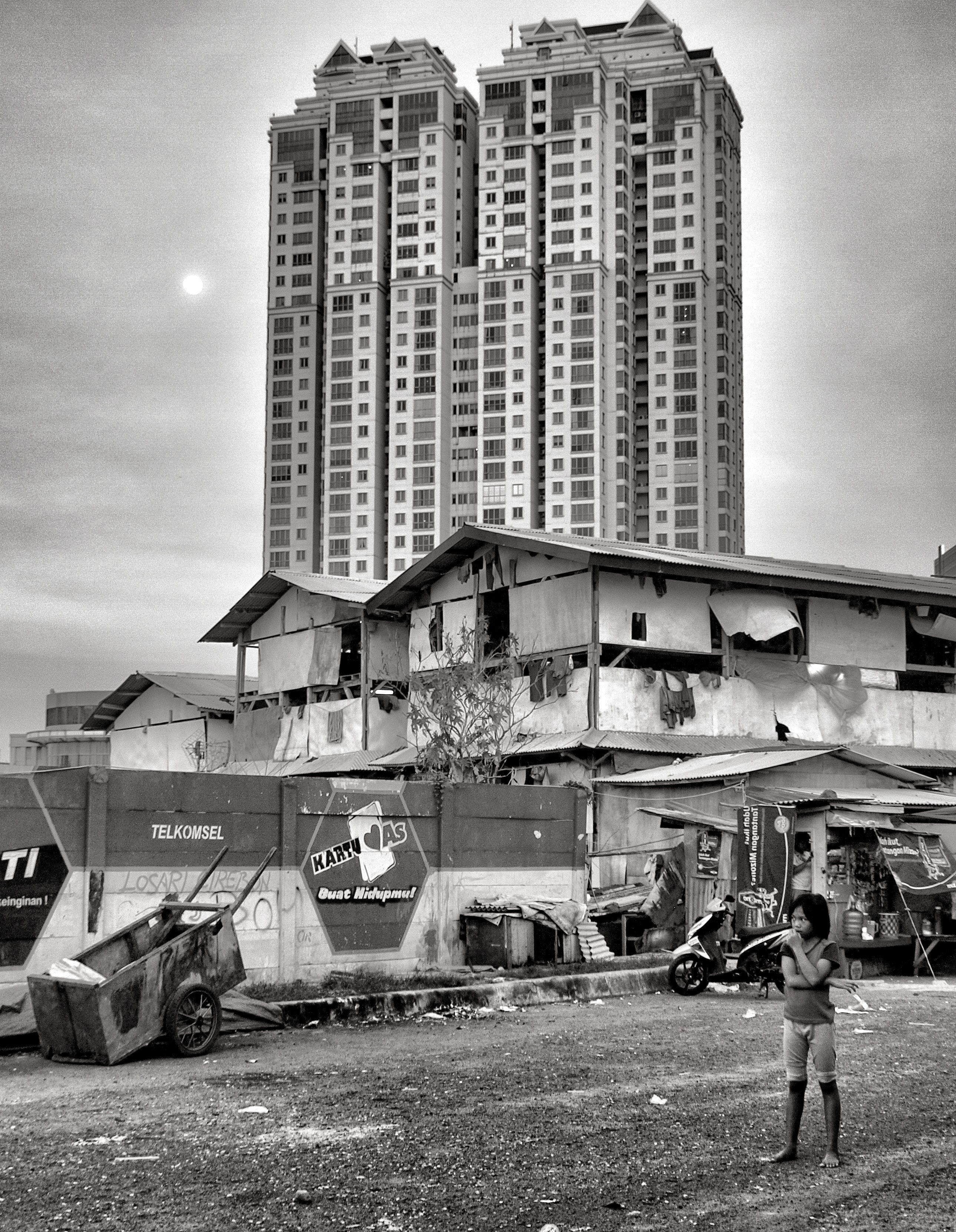 High-rise towers contrasted against low rise slum building